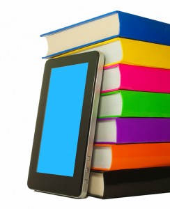 Stack of colorful books and tablet PC